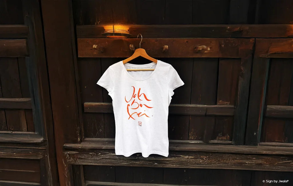 Weißes T-Shirt mit der Botschaft „Ich bin frei“ aus dem Onlineshop SignShop Tirol – handgemachte Mode, inspirierende Kleidung, positive Affirmation, Tiroler Handwerkskunst.